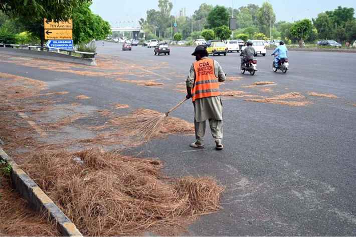 Sanitary Worker Cleans Faisal Avenue Post Storm
