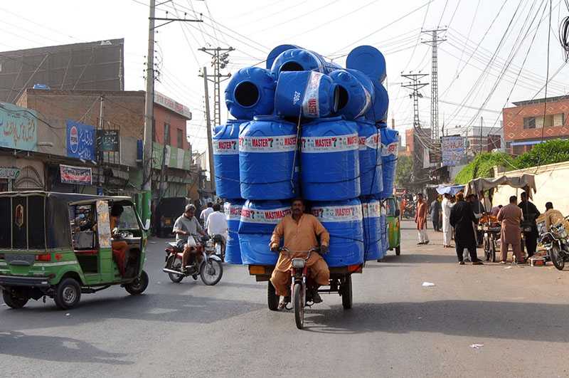 Man Transports Heavy Plastic Water Tank Load Risky On City Road
