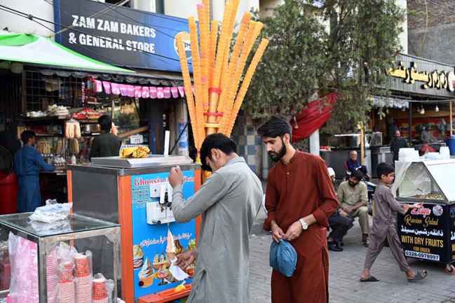 Vendor Display Ice-Cream Cones Attract Customers On Hot Day In City