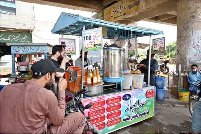 A roadside vendor serving traditional lemonade to beat the heat