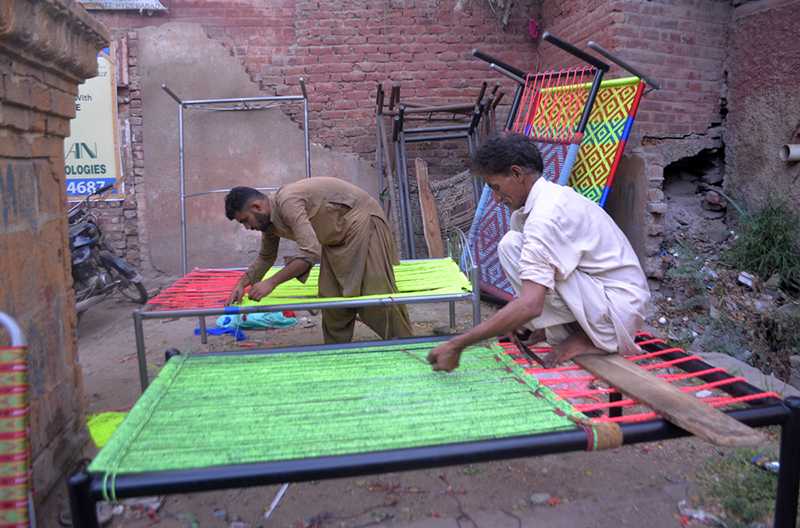 Artisans Skillfully Weave Traditional Charpoys at Local Workshop in Pakistan