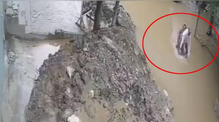 Lahore: Motorcyclist Plunges into Rainwater-Filled Hole (Watch)