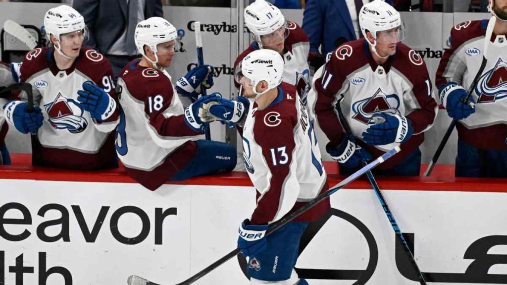 Colorado Avalanche players celebrating after clinching the first NHL playoff berth of the season.