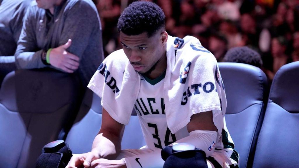 Milwaukee Bucks star Giannis Antetokounmpo in action, with his future uncertain due to ownership issues.
