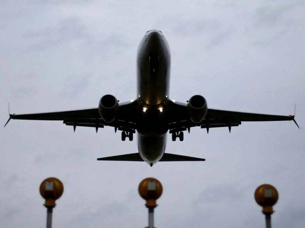 Commercial airplanes at an airport terminal awaiting takeoff amid discussions over Indian airline fare caps.